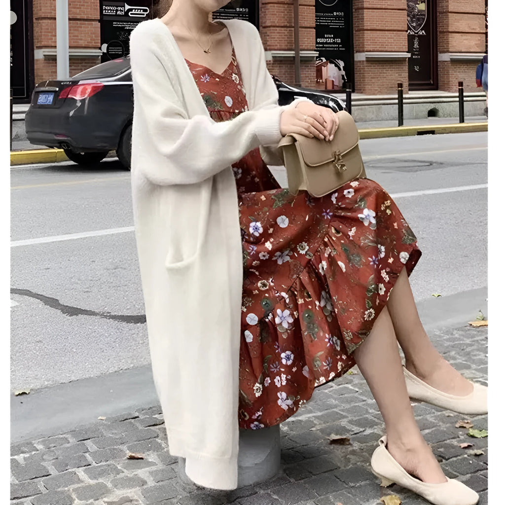 Women loose mid-length knitted cardigan in solid colour with long sleeves and pockets.