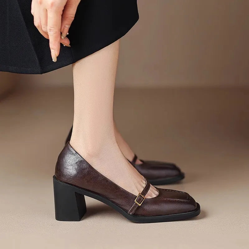 Women's black retro square toe soft high heel pumps with buckle closure on a neutral background