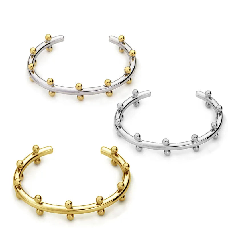 Stainless steel C-shaped bean bead with rivet texture in gold and steel colours for bracelet making.