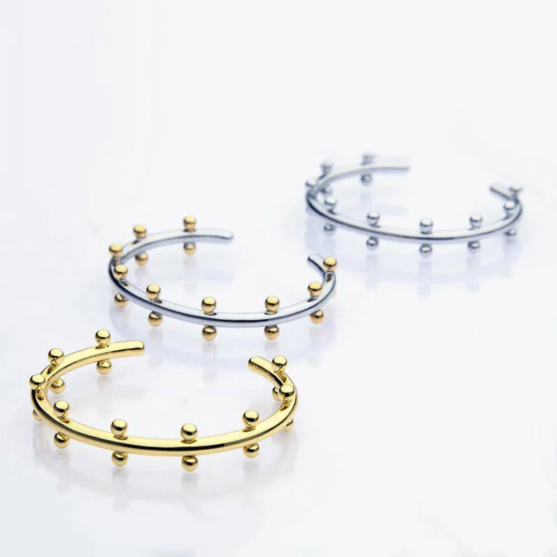 Stainless steel C-shaped bean bead with rivet texture in gold and steel colours for bracelet making.