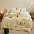 Milk fibre four-piece bedding set with green Christmas tree pattern on a duvet cover and pillowcases.