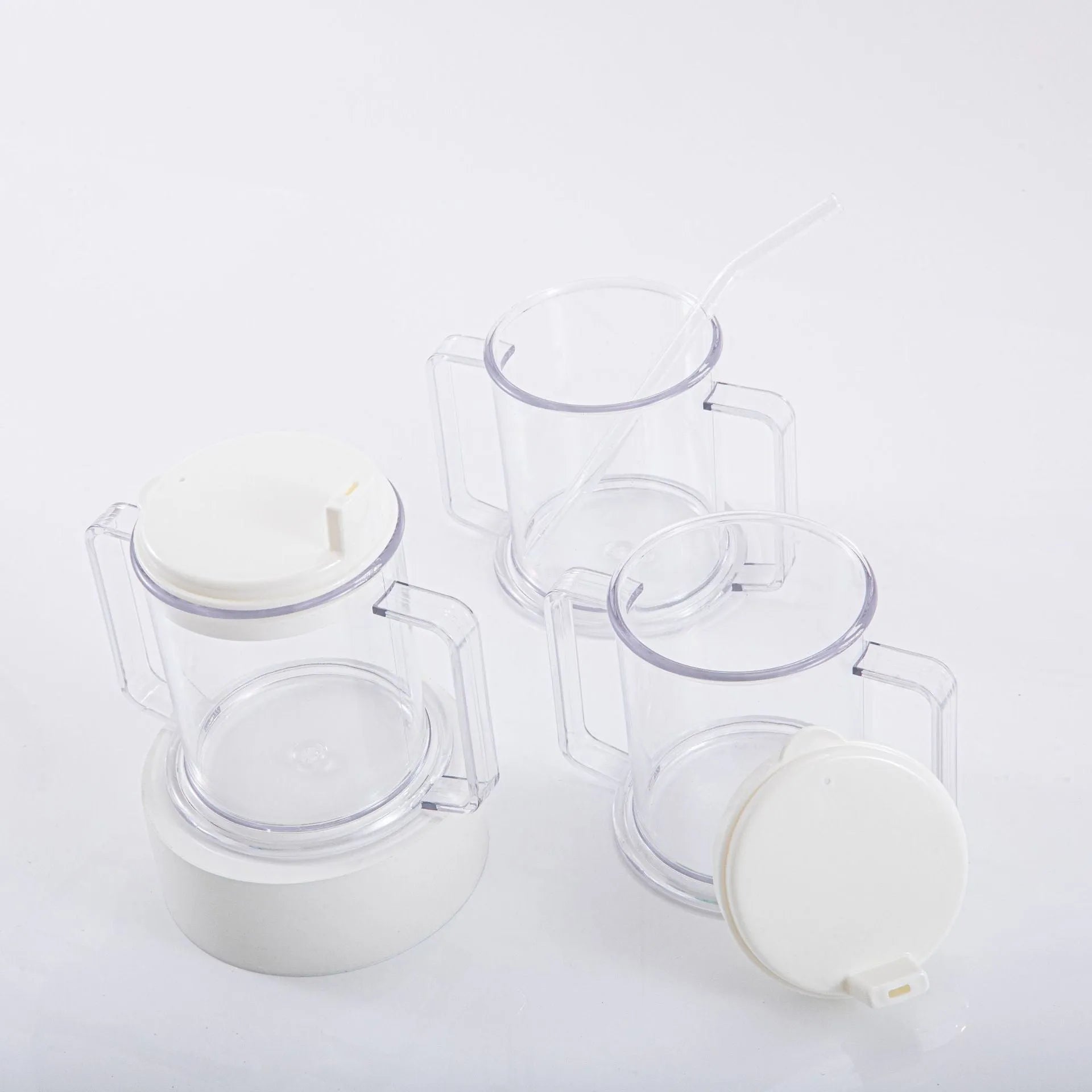 Transparent plastic drinking cup with spill-proof design on a plain background.