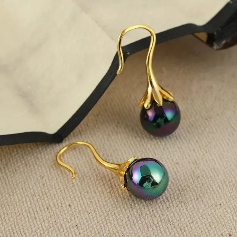 A pair of gold-coloured retro fashion earrings for women with an alloy construction.