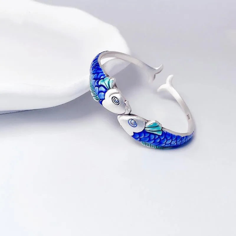 Silver electroplated copper bangle with blue carp design under glossy epoxy finish, 60mm diameter.