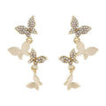 Gold tone butterfly drop earrings with four copper charms on each piece for women