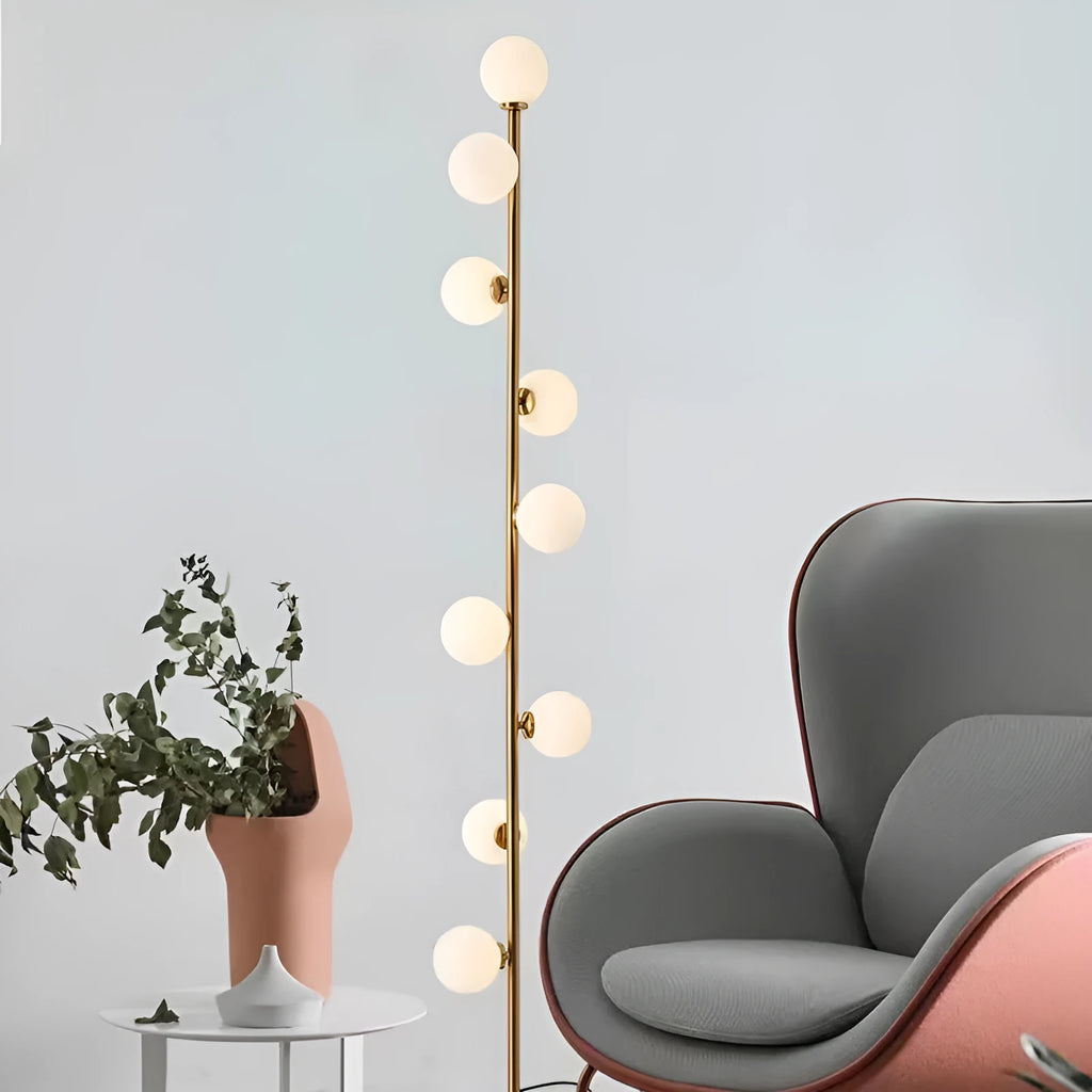 Tall modern floor lamp with glass shade and ironwork base on a wooden floor, showing minimalist Nordic design.