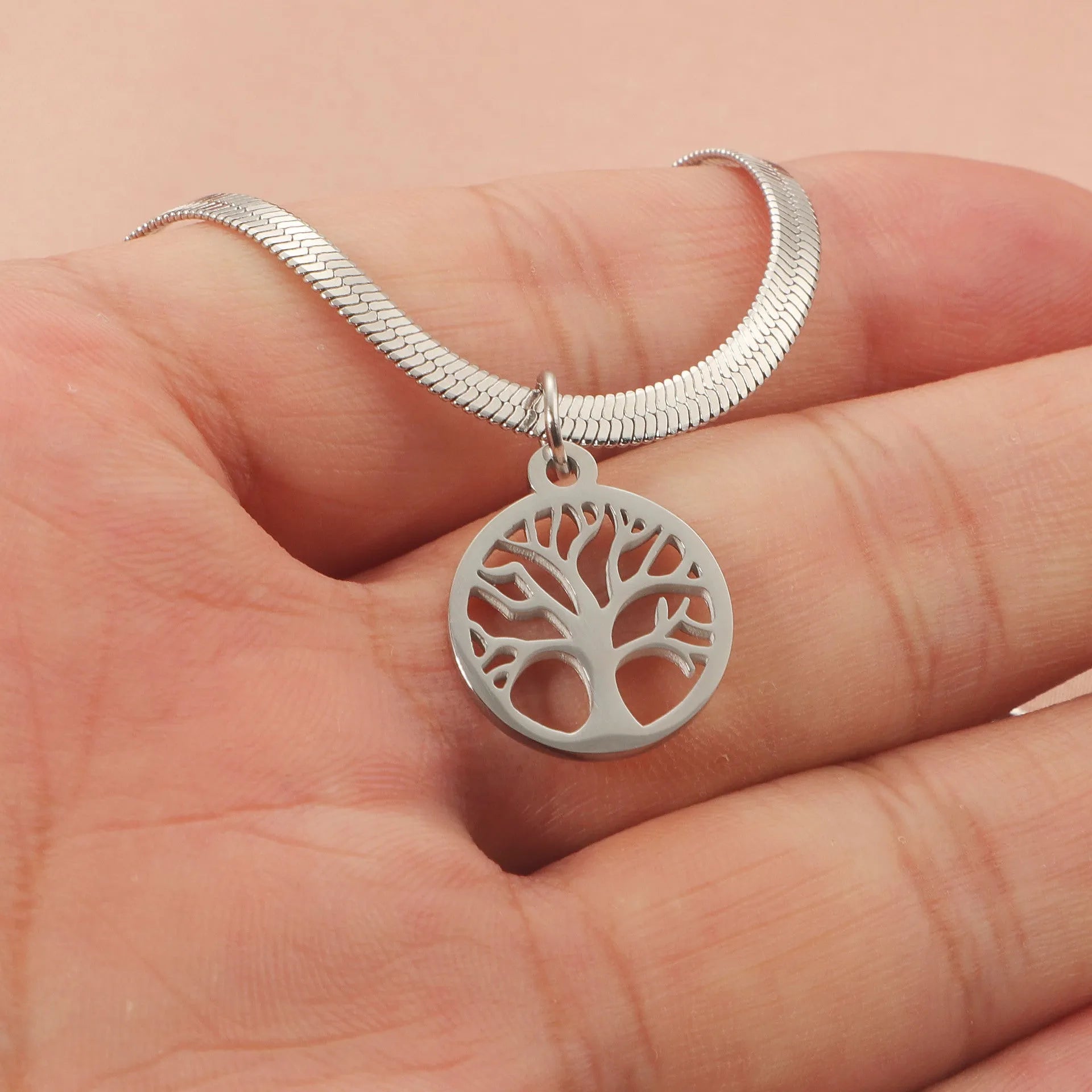 Stainless steel lucky tree necklace with snake bones chain, shown in gold and steel colour options.