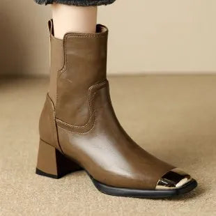 Brown women's knee-high cowhide leather Martin boots with a heel and side zipper detail.