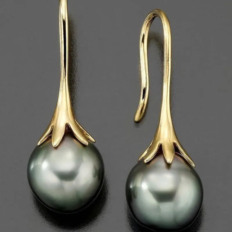 A pair of gold-coloured retro fashion earrings for women with an alloy construction.
