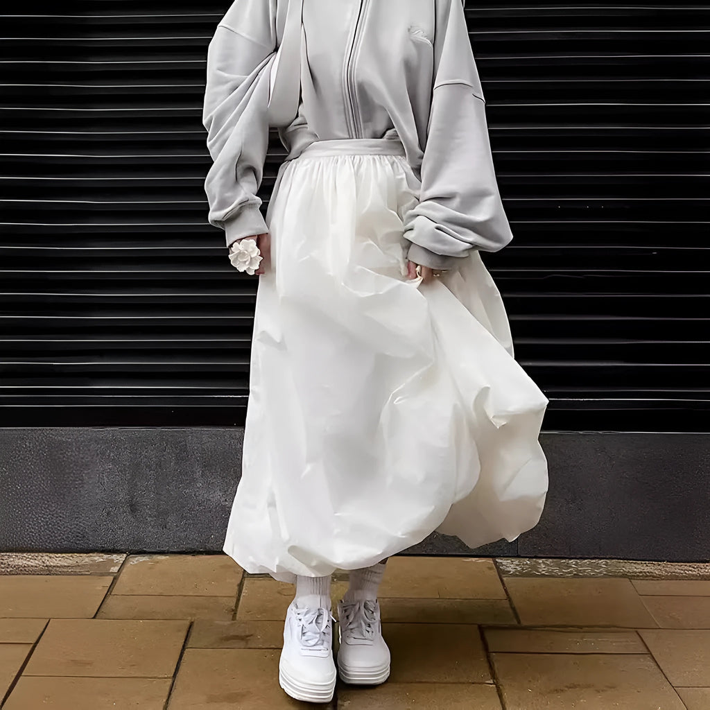 Women's solid colour long cotton skirt on a hanger, available in black and white.