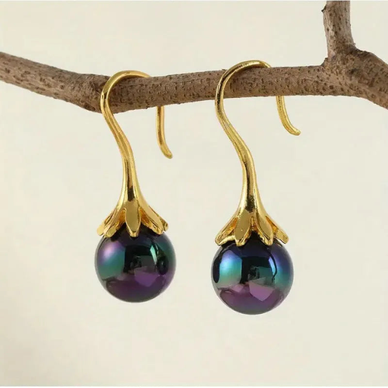 A pair of gold-coloured retro fashion earrings for women with an alloy construction.