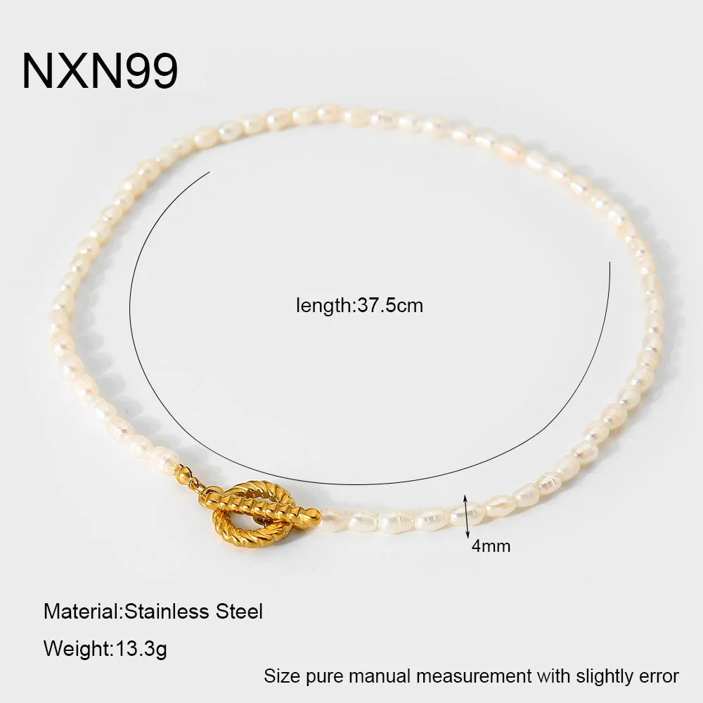 Women's freshwater pearl and geometric stainless steel necklace and bracelet set on a grey background