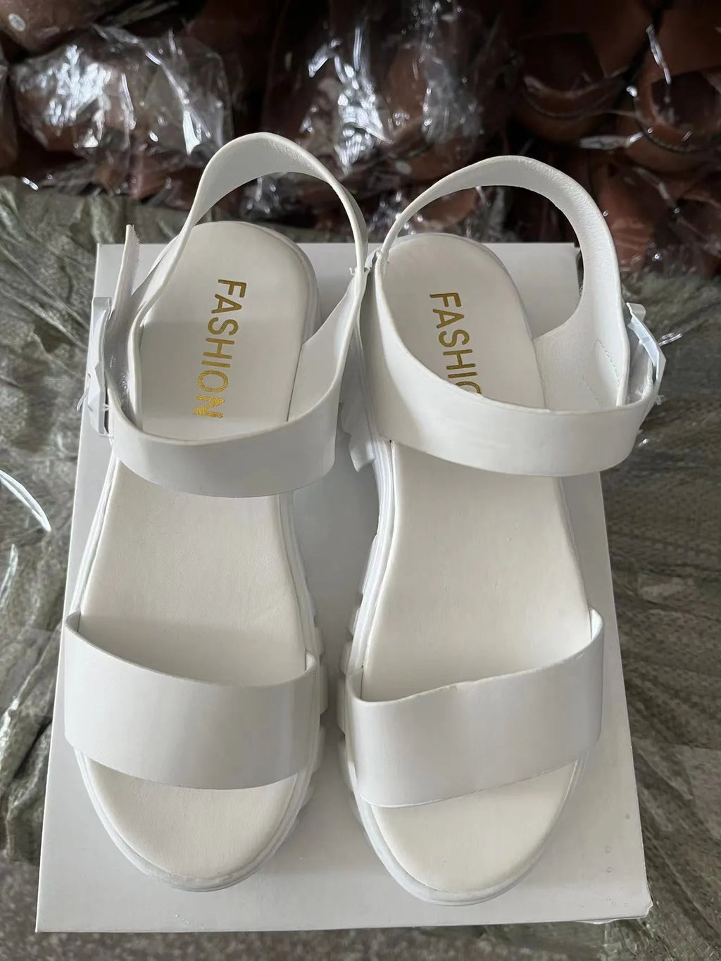 Women's beige peep toe platform sandals with an ankle-strap buckle on a white background