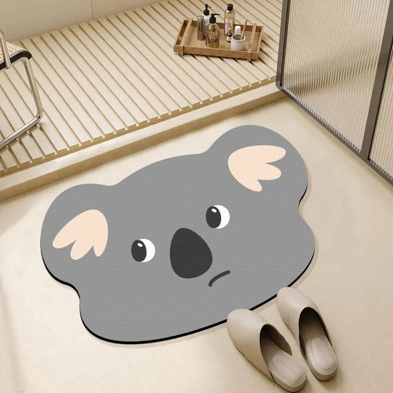 Cute cartoon animal diatomaceous earth bath mat in alien shape on bathroom floor.