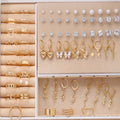 108 geometric pearl earrings in gold and yellow electroplated alloy arranged in combination set