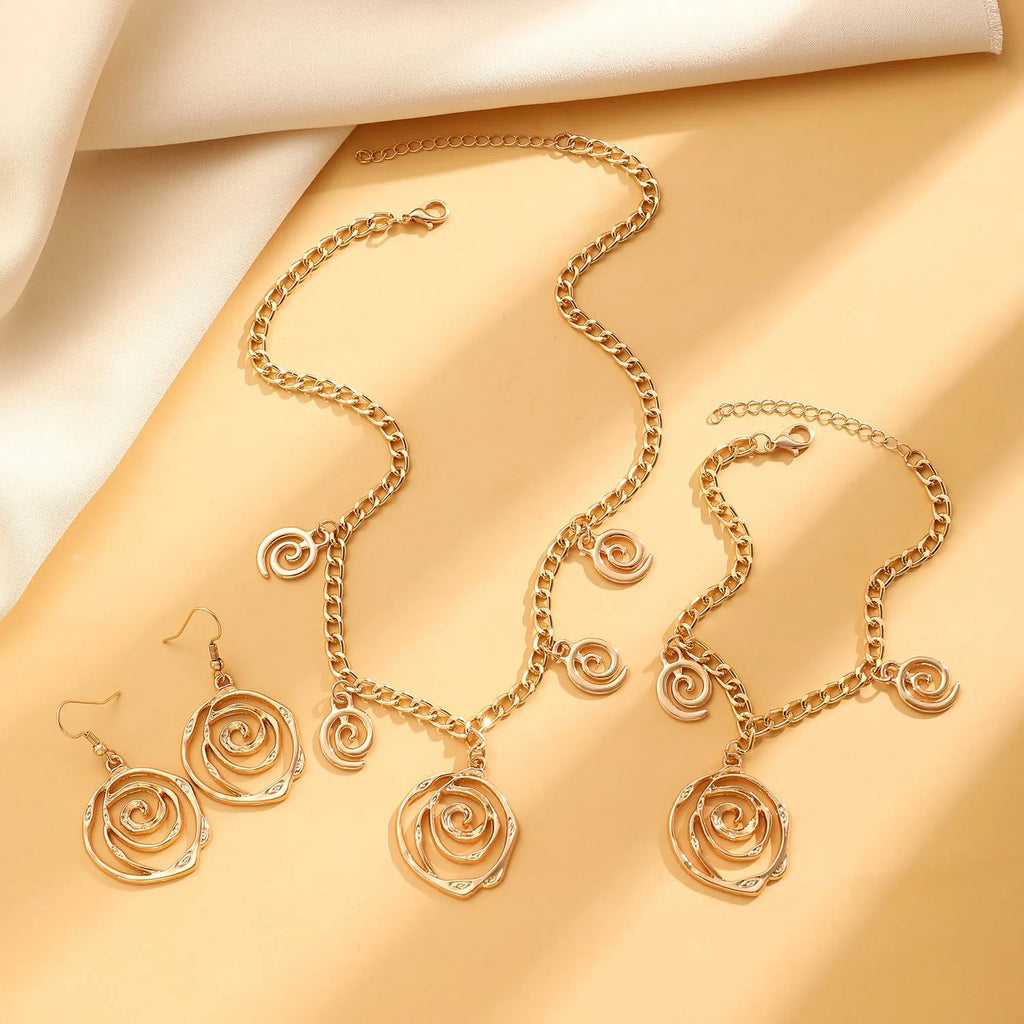 Spiral donut design jewellery set showing necklace, bracelet and ear hooks in gold finish
