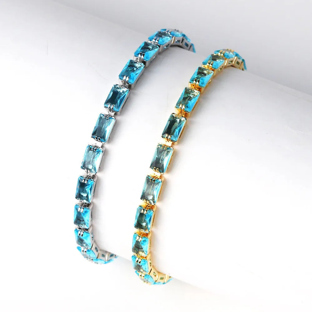 Women's fashion zircon bracelet in alloy with gold electroplated finish and coloured stone settings.