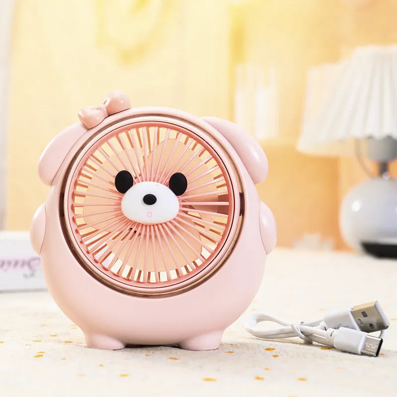 Cute dog-shaped plastic desktop electric fan in light pink puppy colour, with USB cable.