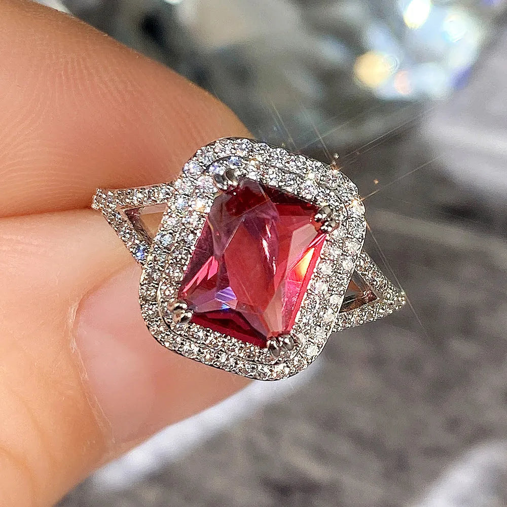 Women's square copper ring with a large red rhinestone set in a geometric princess style.