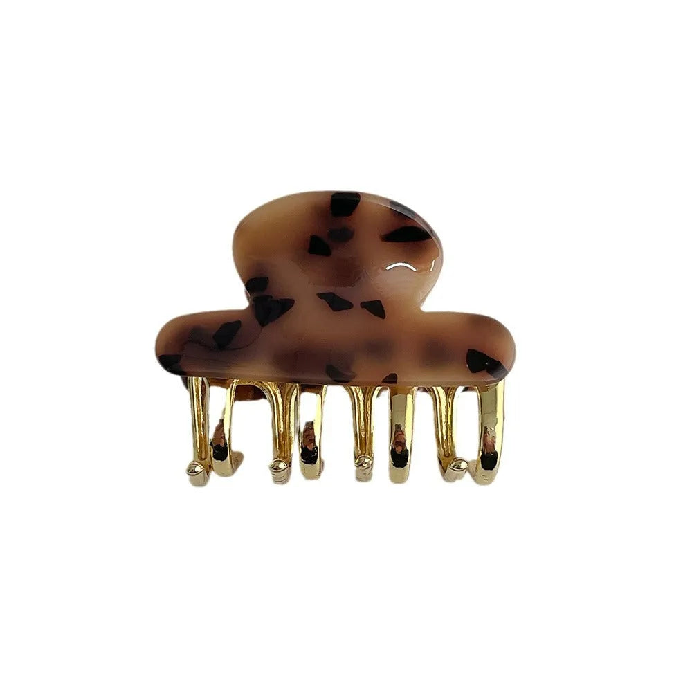 Medium metal grip women's barrette in retro acetate style, alloy acrylic construction, shown in one of four colour options.