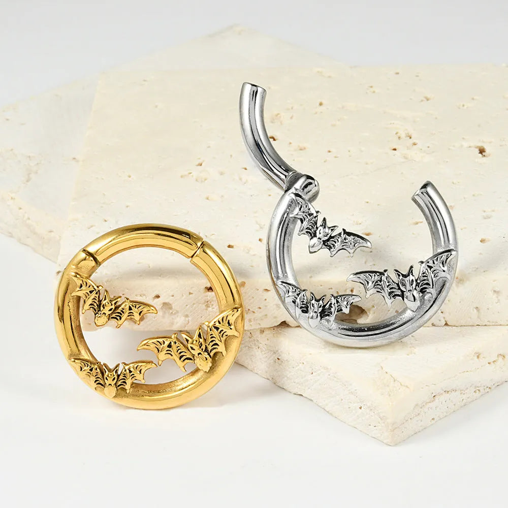 Stainless steel fashion earrings with a detailed totem pattern in an electroplated metallic finish