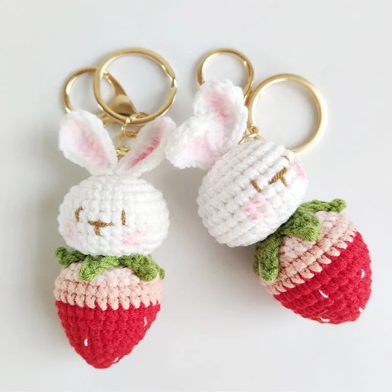 Hand-woven white rabbit strawberry cartoon charm pendant with a key attached