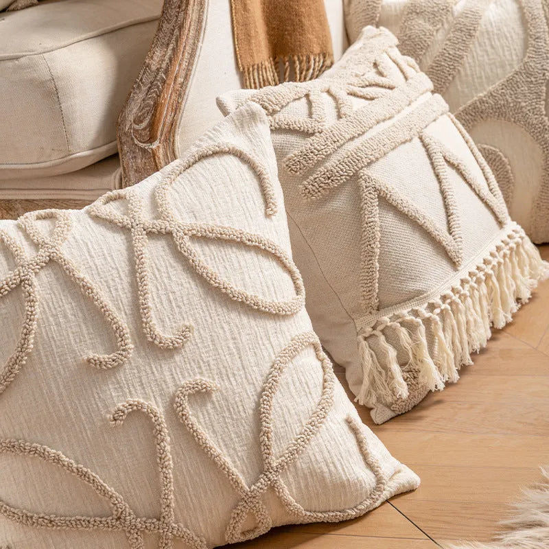 Knitted cushion cover with tassel trim in a choice of patterned designs including spiral dots and bow.