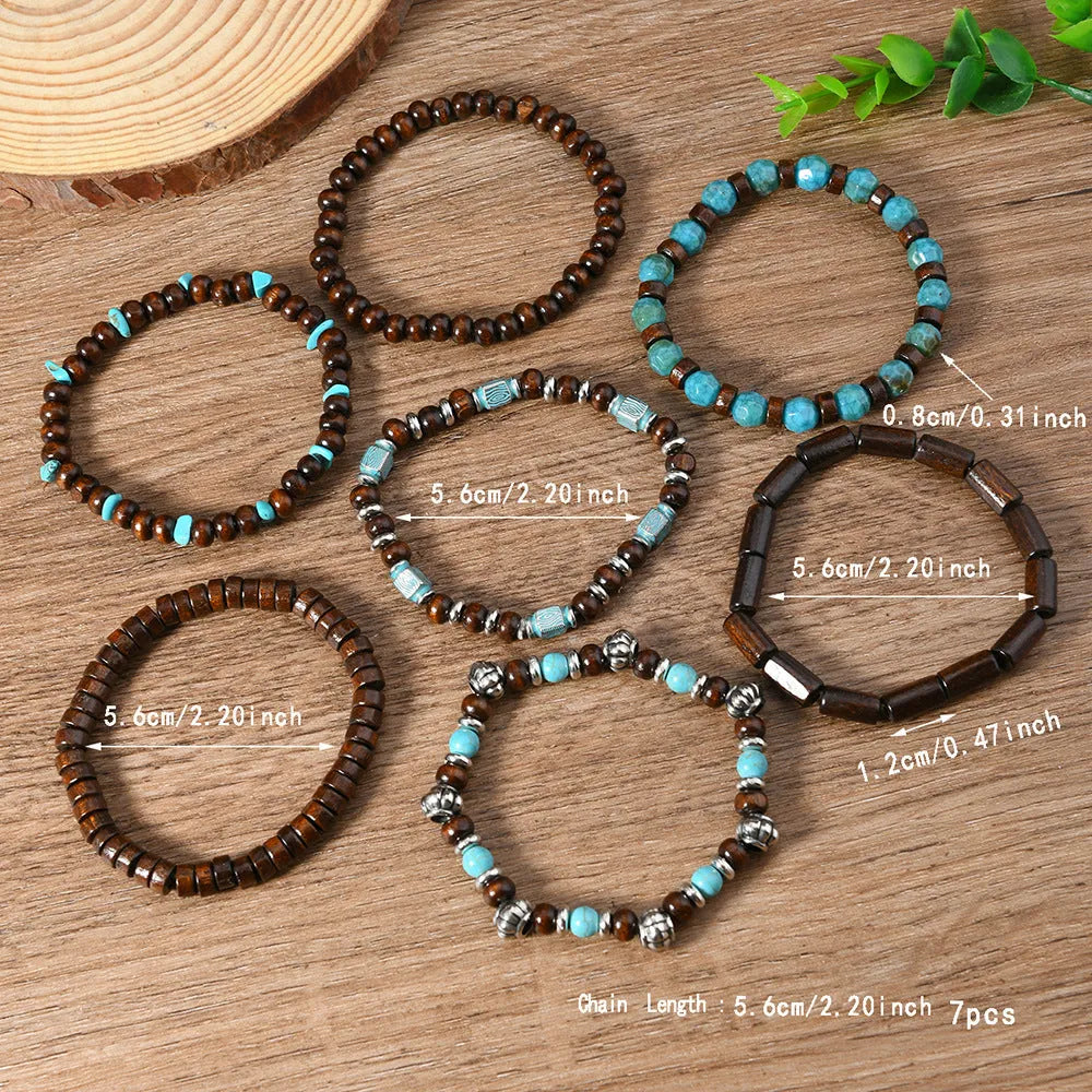 Set of seven multicolour retro bracelets with wooden beads and alloy accents laid flat.