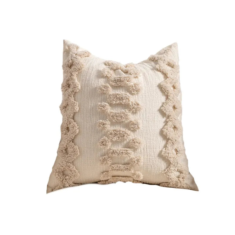 Knitted cushion cover with tassel trim in a choice of patterned designs including spiral dots and bow.