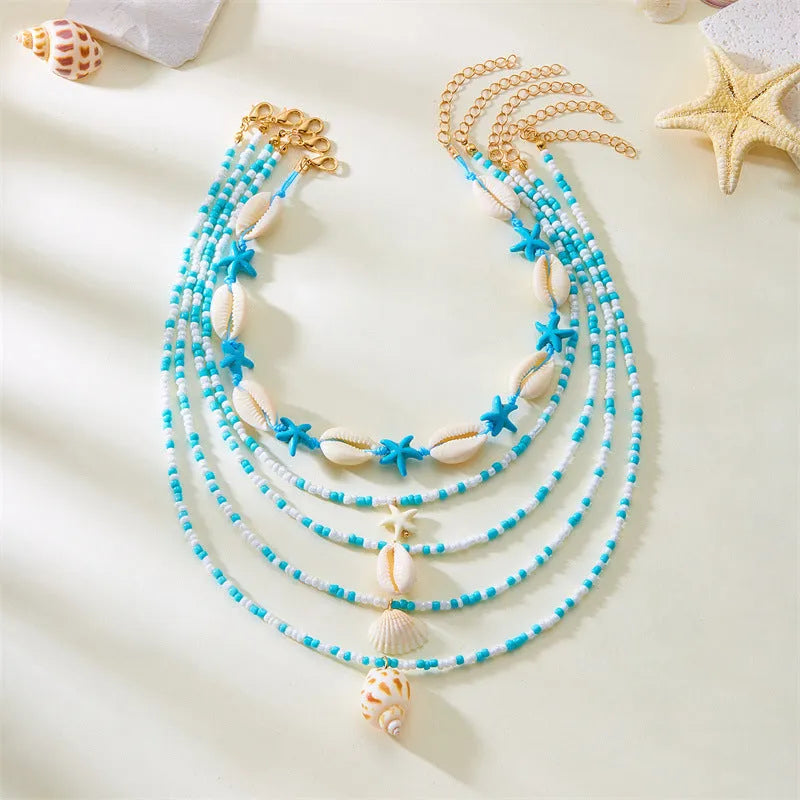 Five-piece women's necklace set with starfish shell and conch bead designs on adjustable chain