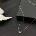 Women's gold geometric pendant necklace with quadrilateral design and inset cubic zirconia stones on chain