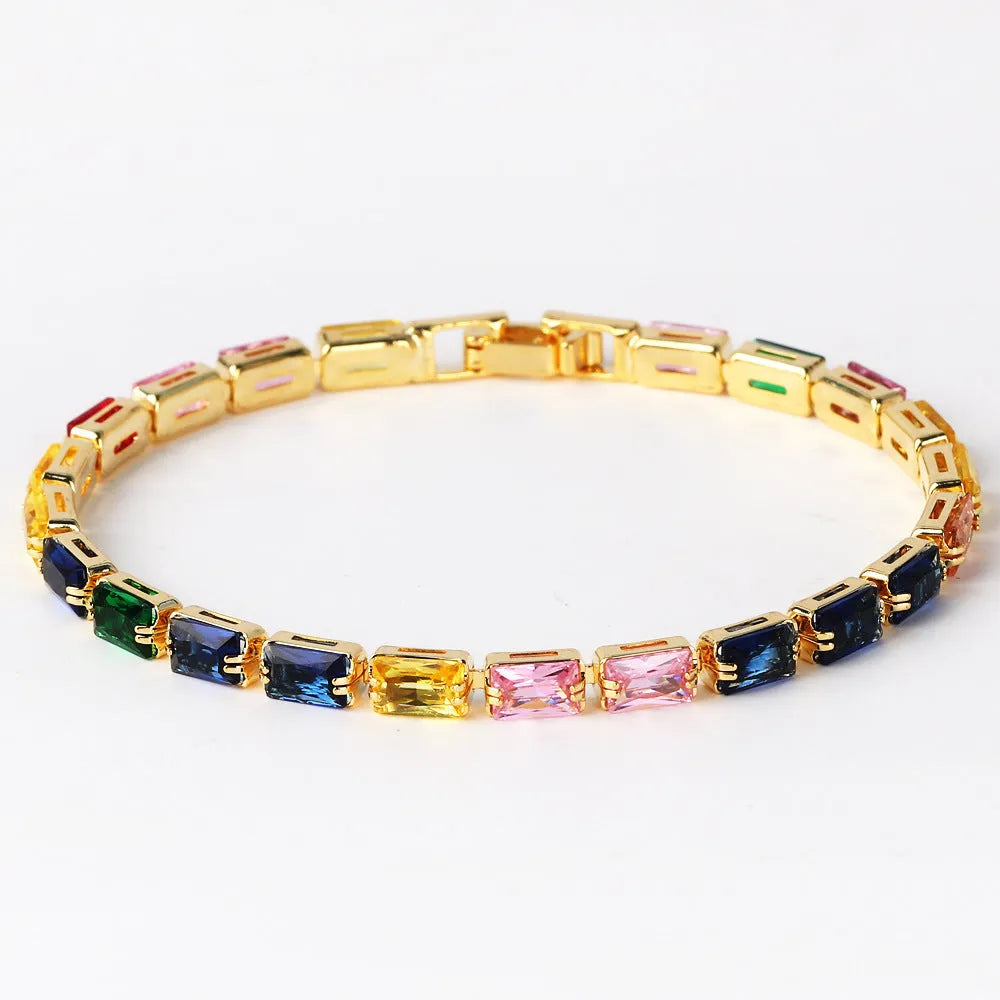 Women's fashion zircon bracelet in alloy with gold electroplated finish and coloured stone settings.