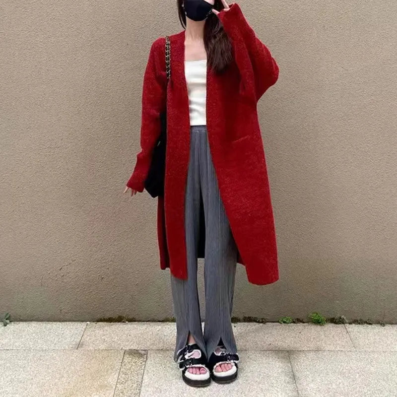 Women loose mid-length knitted cardigan in solid colour with long sleeves and pockets.