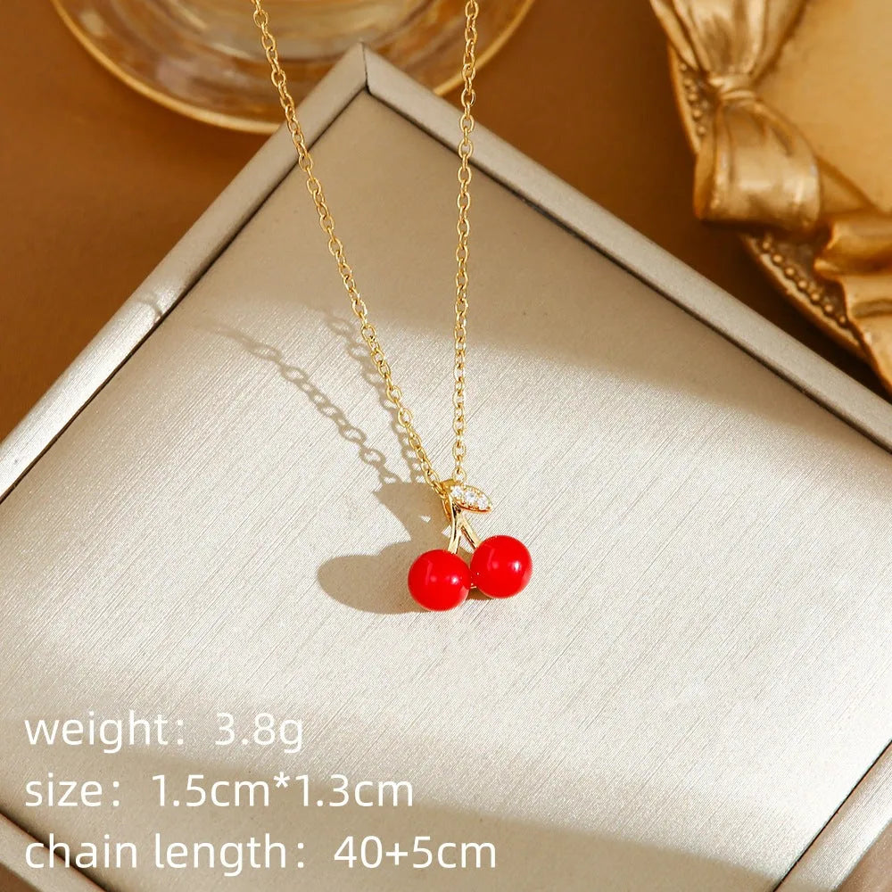 Titanium steel indie necklace with O-ring chain and a choice of cherry, strawberry, or pepper pendant in golden or steel finishes.
