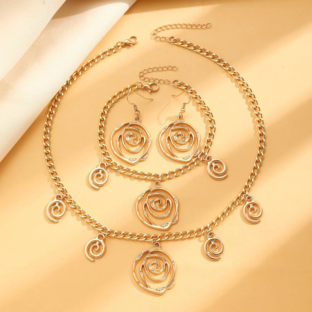Spiral donut design jewellery set showing necklace, bracelet and ear hooks in gold finish