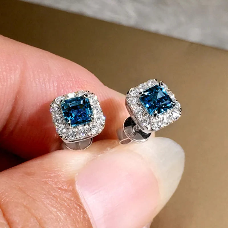 Square-cut grandmother green zircon stud earrings in electroplated copper with gold or white gold colour options.
