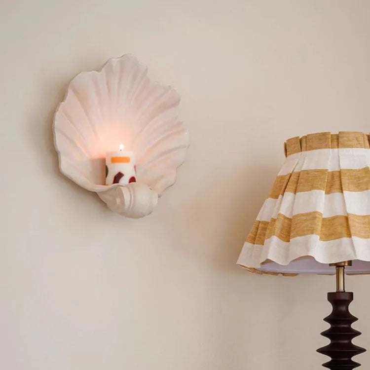 White resin fruit plate ornament shaped like a shell on a table