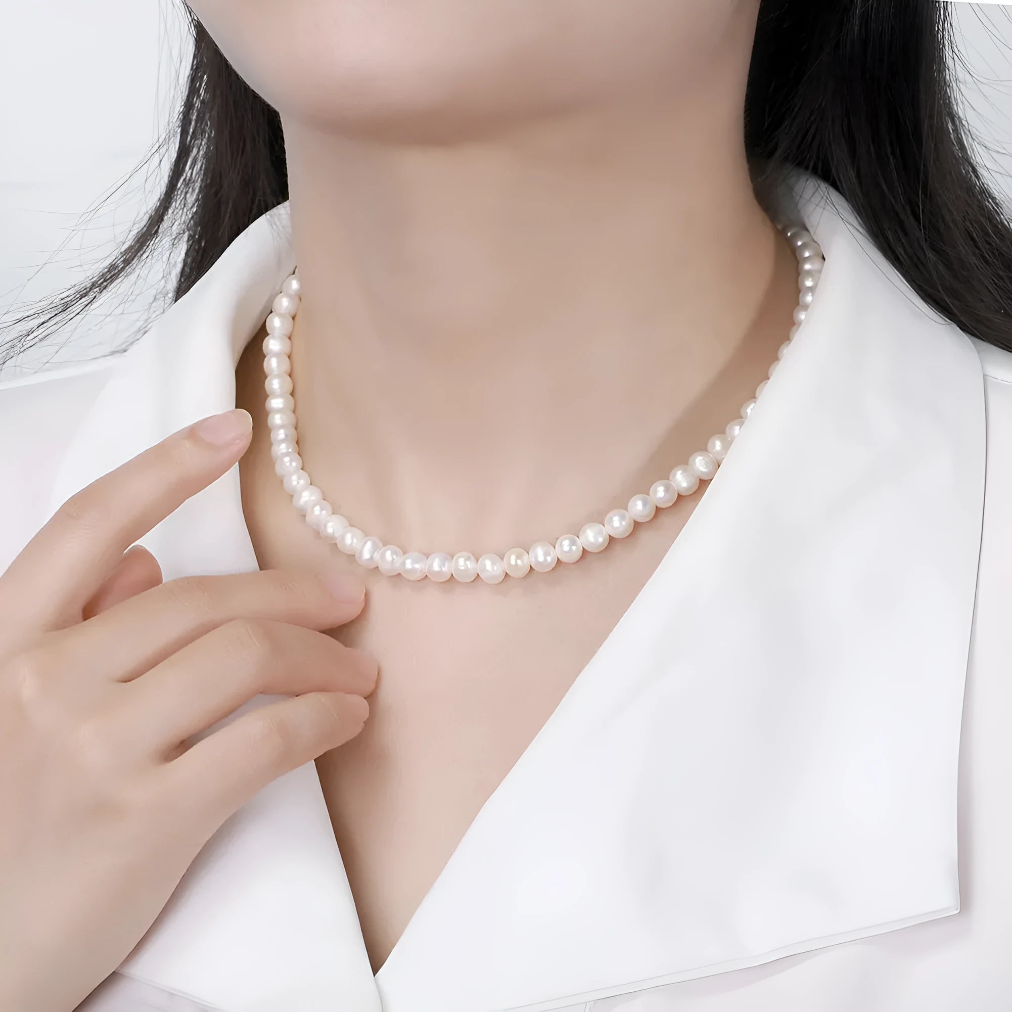 Women's adjustable necklace with natural freshwater pearls on a sterling silver chain.