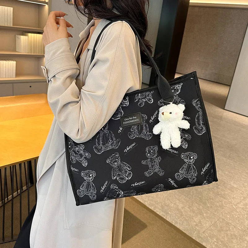 Women's printed canvas tote bag with rhombus pattern showing horizontal square shape and shoulder strap
