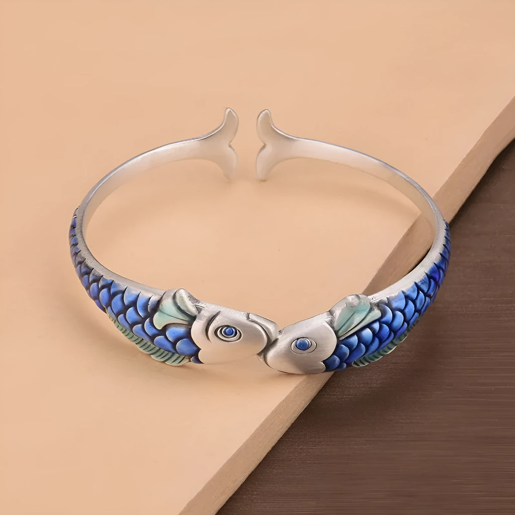 Silver electroplated copper bangle with blue carp design under glossy epoxy finish, 60mm diameter.