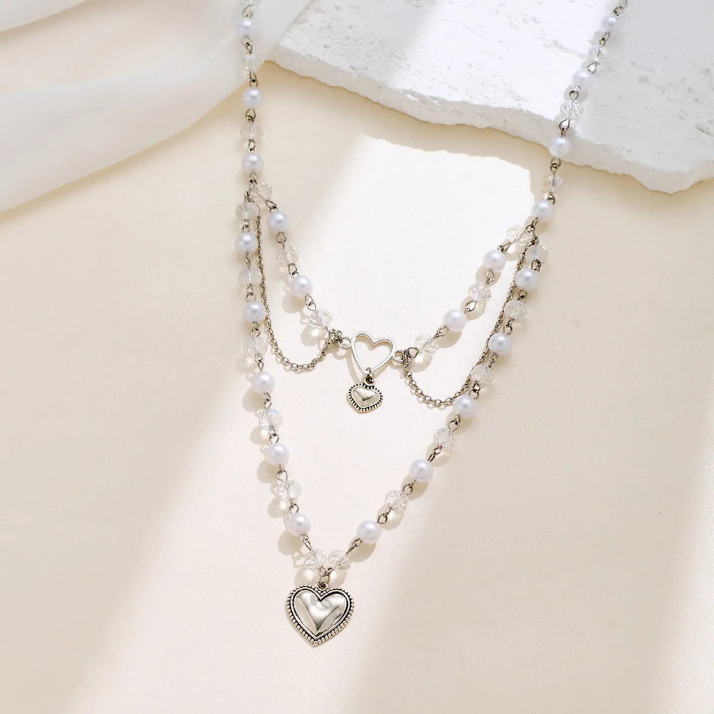 Women's retro alloy love heart pendant necklace with multi-layer pearl chain and double-layer heart design