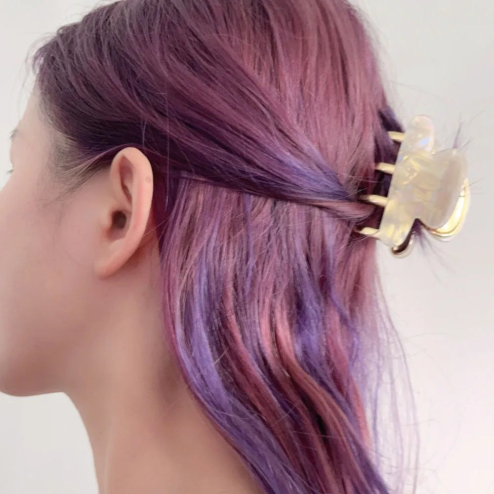 Medium metal grip women's barrette in retro acetate style, alloy acrylic construction, shown in one of four colour options.