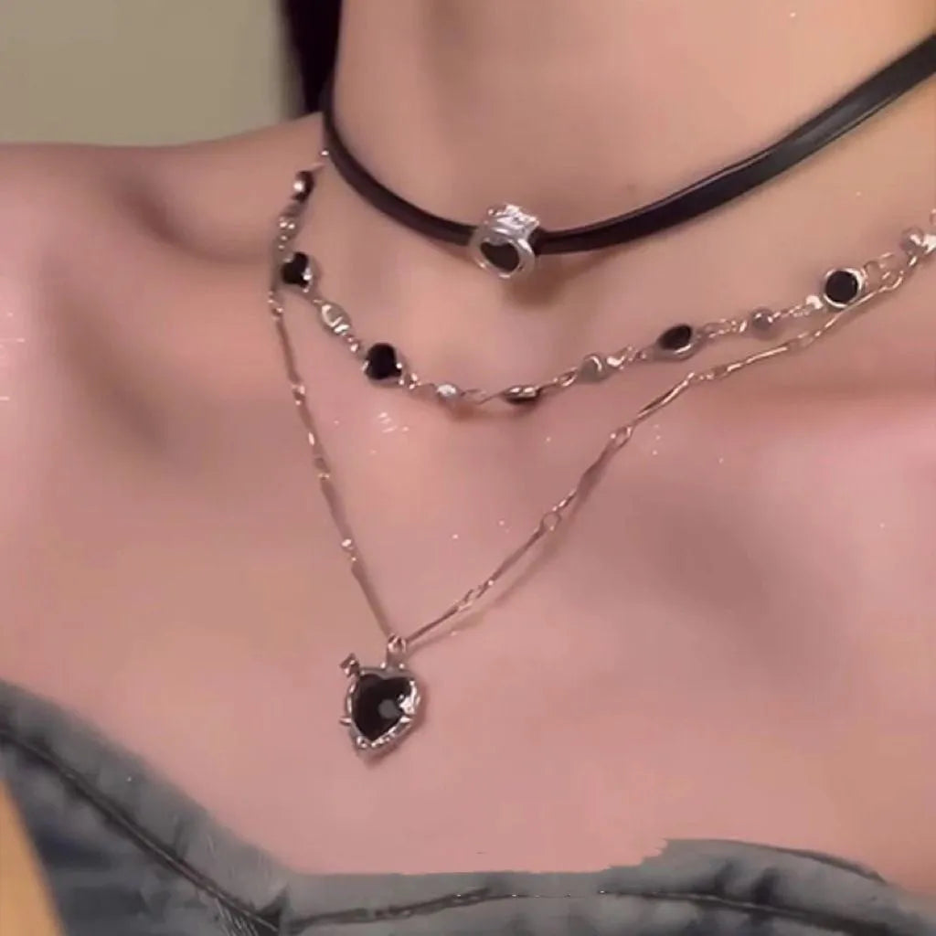 Women's multi-layer heart necklace set with alloy pendant, artificial crystal, and leather accents on an adjustable clavicle chain.