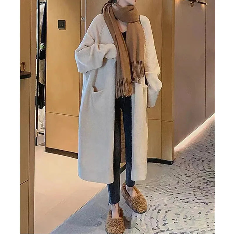 Women loose mid-length knitted cardigan in solid colour with long sleeves and pockets.