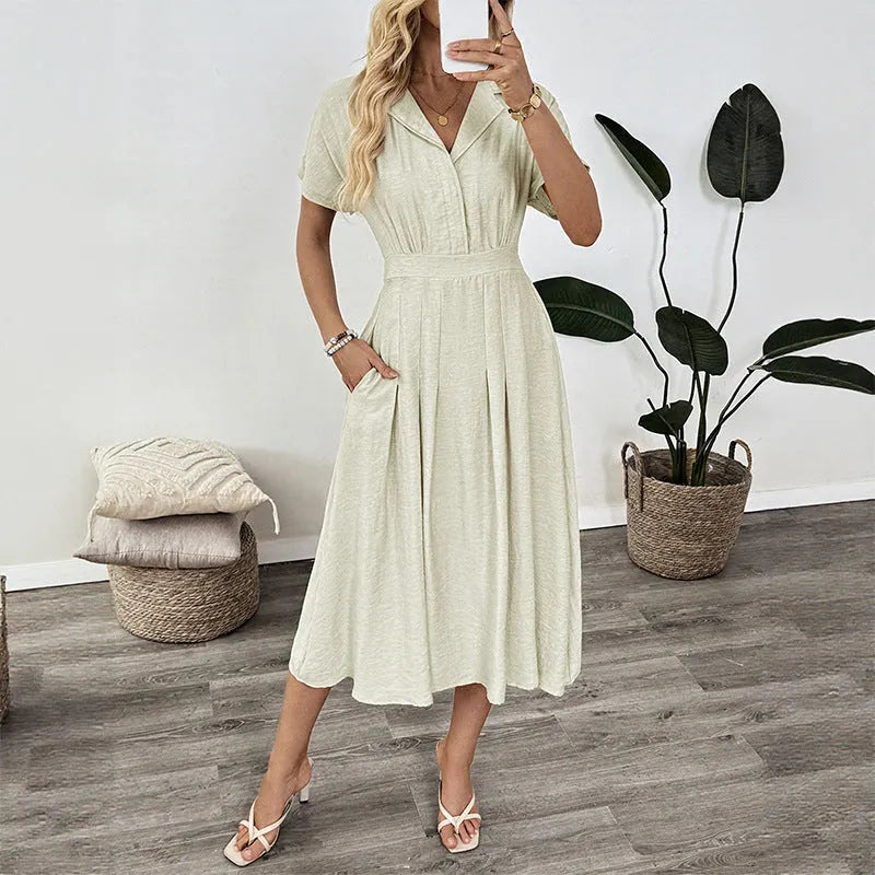 Light green commuter shirt dress with lapel collar, waist tie, and side pockets on a hanger.