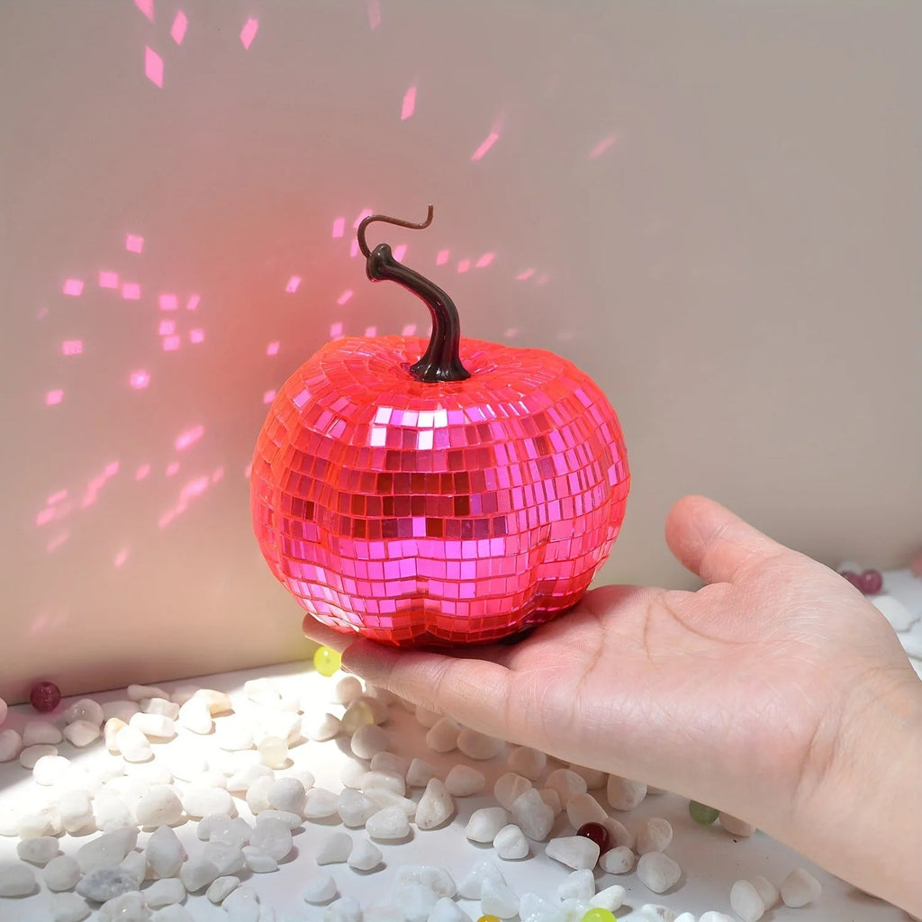 Chinese style glass Halloween pumpkin decoration in five different sizes on a dark surface.