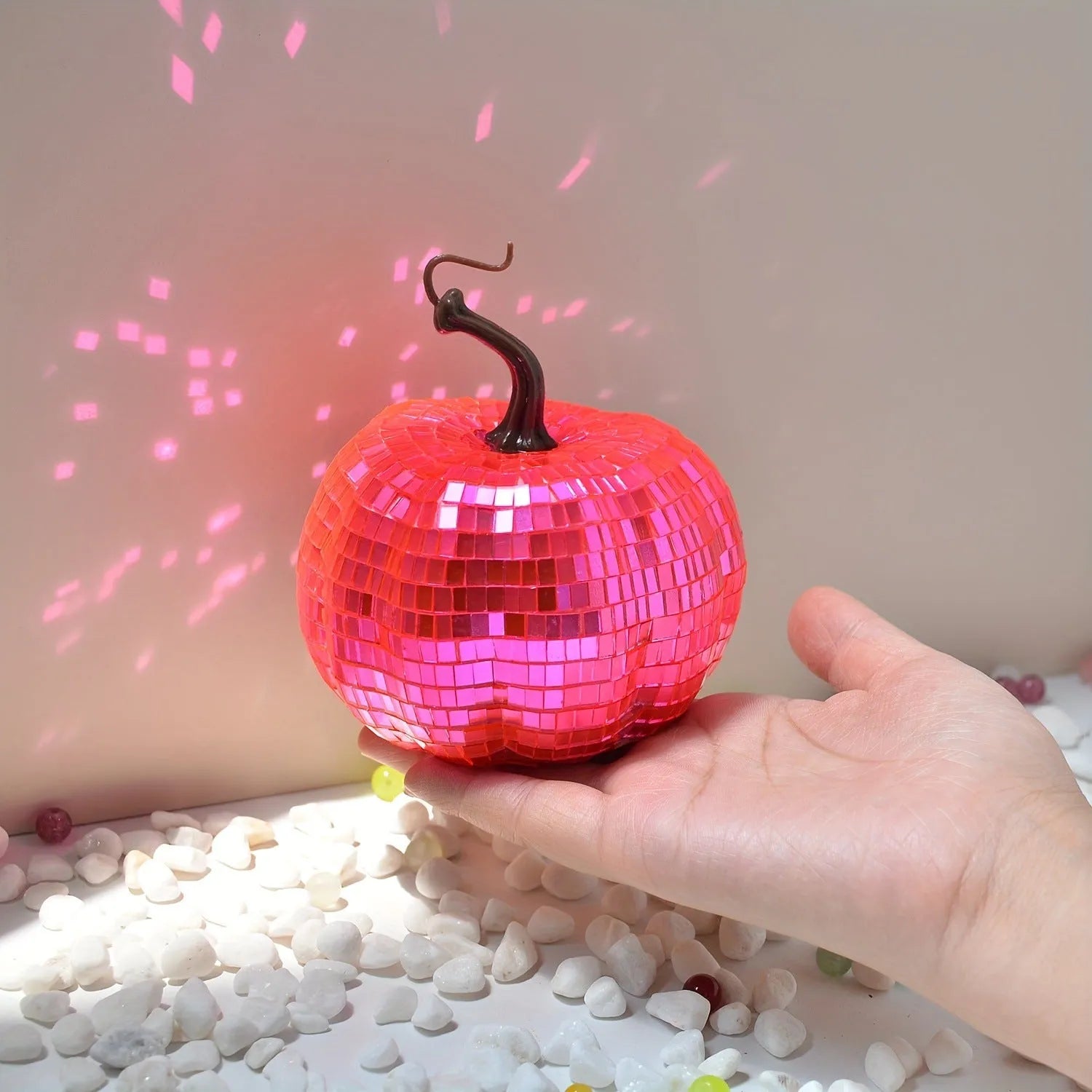 Chinese style glass Halloween pumpkin decoration in five different sizes on a dark surface.