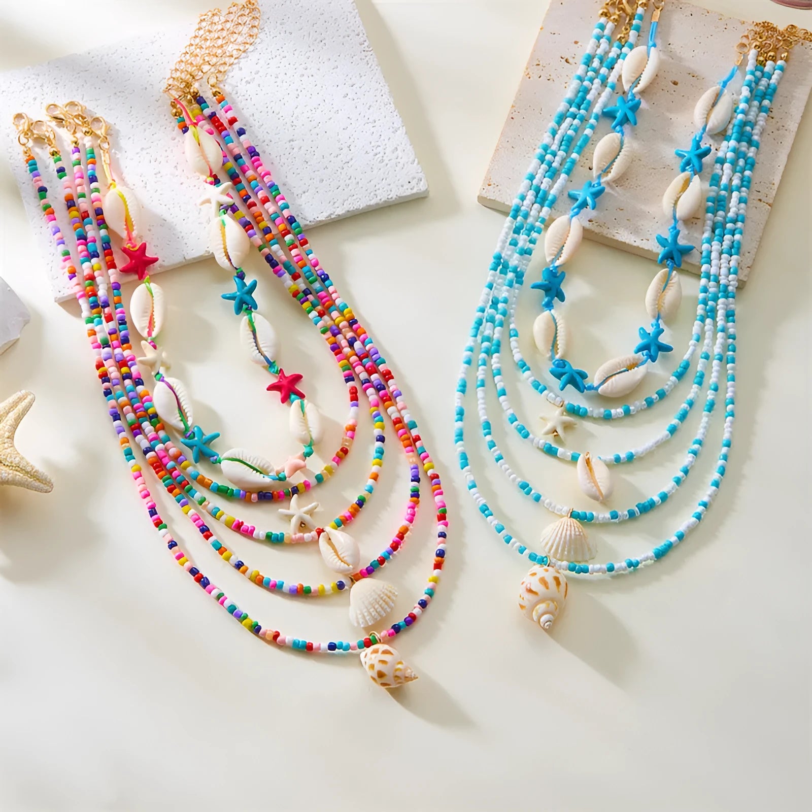 Five-piece women's necklace set with starfish shell and conch bead designs on adjustable chain