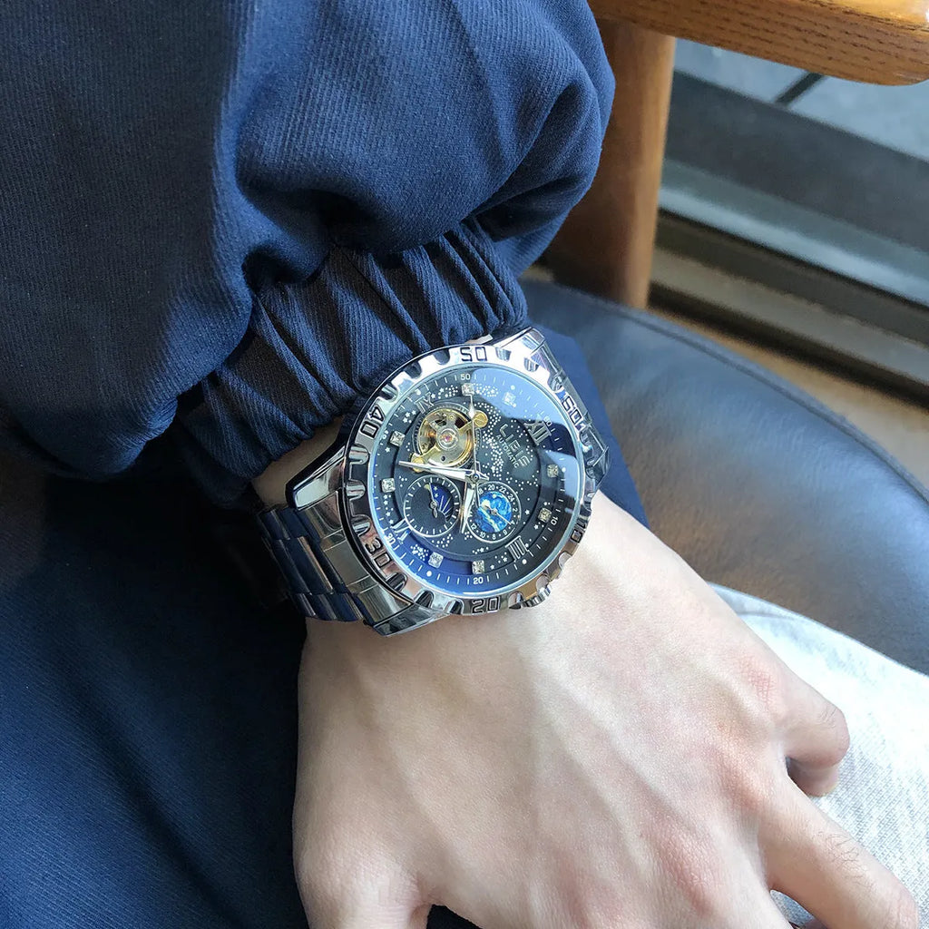Men's silver case automatic watch with black starry luminous dial on a black steel belt.