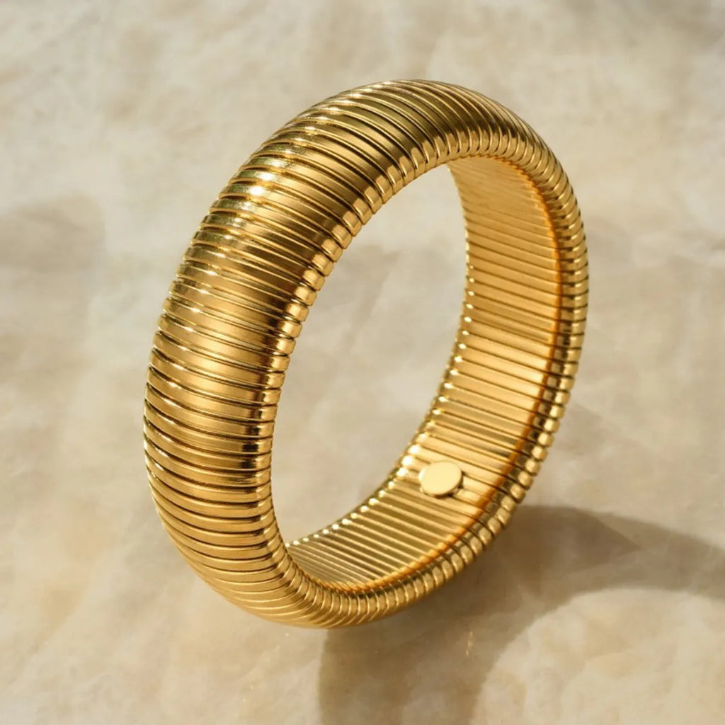 Women's titanium steel elastic bracelet with vertical stripe pattern in gold or silver, shown in various width sizes